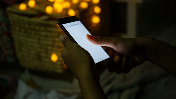 close up of a person's hands holding a cellphone