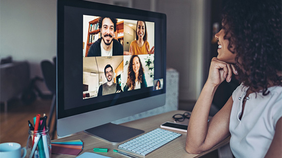 young woman on computer, a zoom meeting on the screen