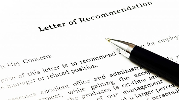 close-up of a letter of recommendation with a pen sitting on top of it