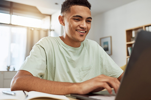 young man working on laptop at home