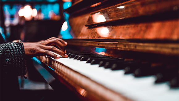 close up of hands on a piano