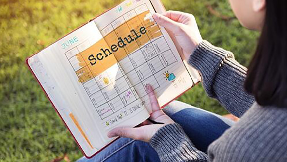 female college student looking at a schedule planner