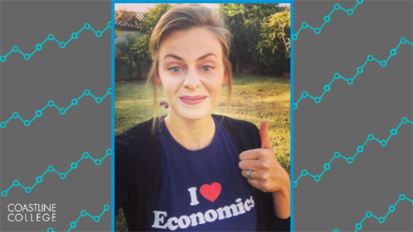 coastline instructor Stacey Smith shows off her love of Economics with a thumbs up in a t-shirt that reads "I (heart) Economics"