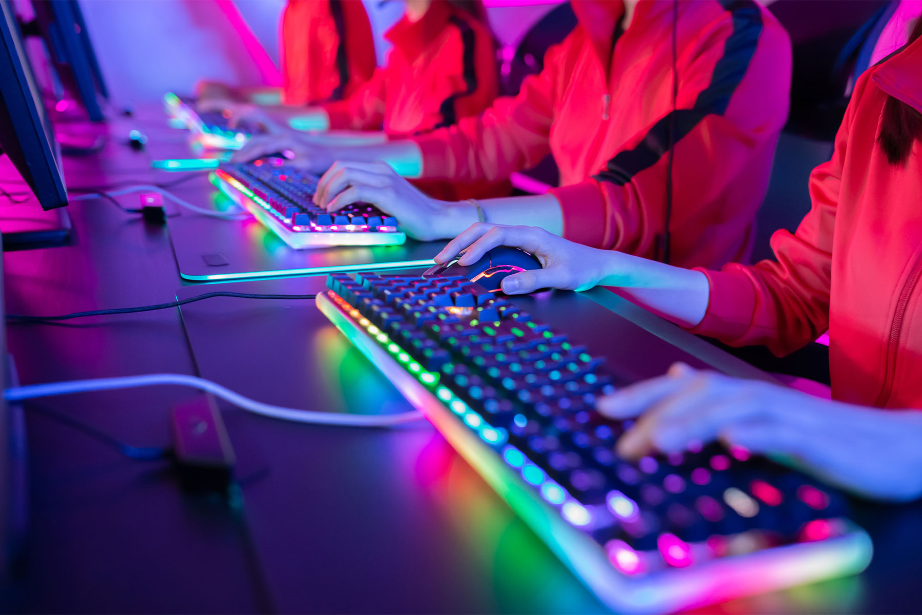 close up of esports team members' hands on keyboards