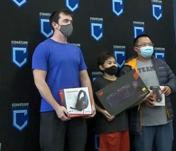winners of the coastline esports tournament line up for a photo with their prizes