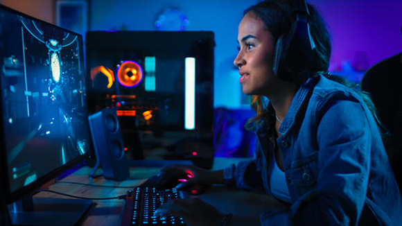 female gamer in the middle of a game battle on a PC computer