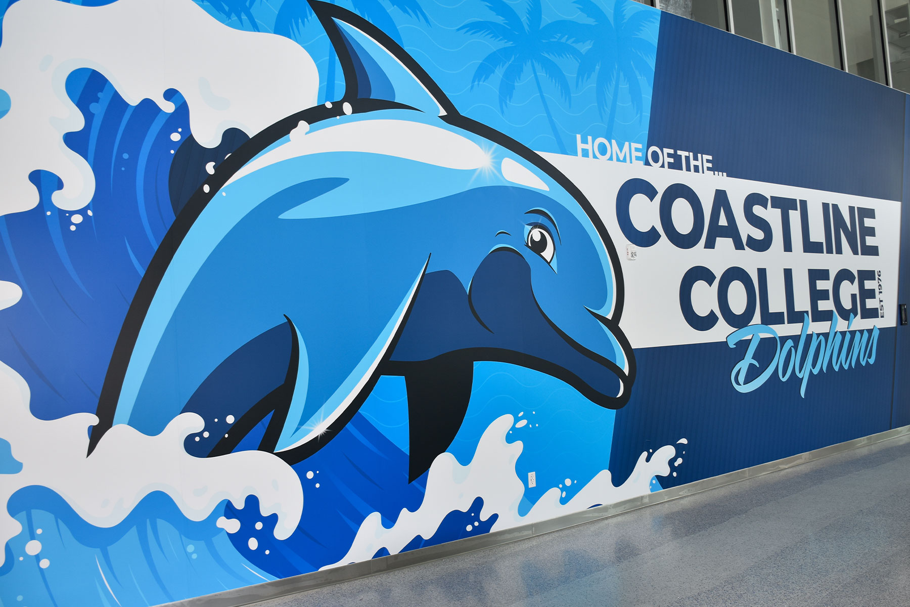 coastline college welcome wall at the fountain valley student services center featuring new mascot, fin