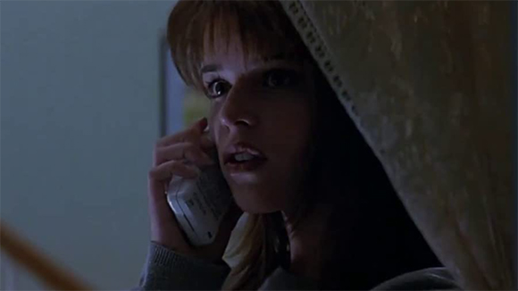 screenshot of Scream star Neve Campbell holding telephone. Source: IMDB