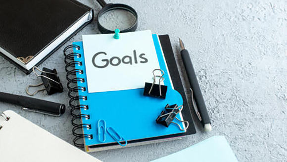 Planner with the word goals written on the front of it. All students should have planners filled with educational goals