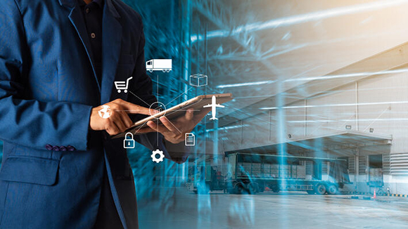 supply chain management concept of someone using a tablet in a warehouse setting with digital overlay