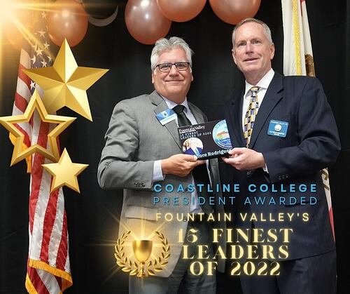 Coastline College President receiving award from Chamber of Commerce member