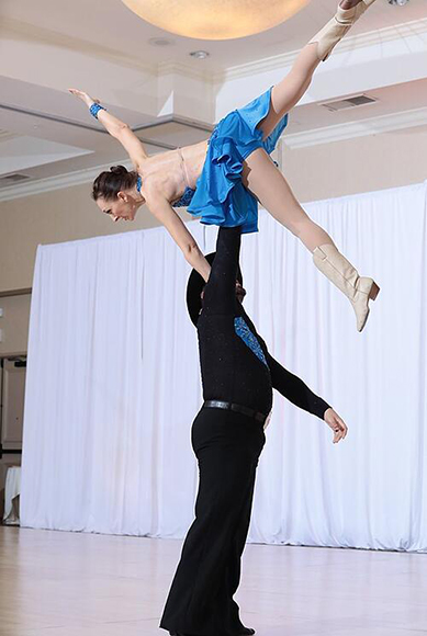 Professor Ruppert and her husband performing a star lift in competitive dancing