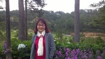 amy tuong in front of lush garden with green grass and large trees