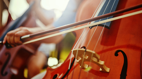 close up of young student playing the cello