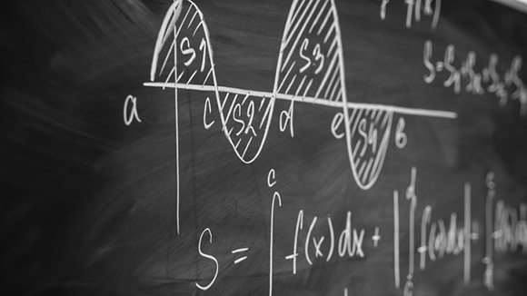 close up of calculus equations written on a blackboard