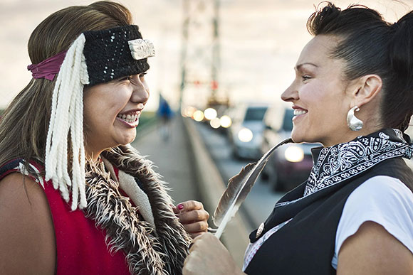 two beautiful native ladies laughing with each other