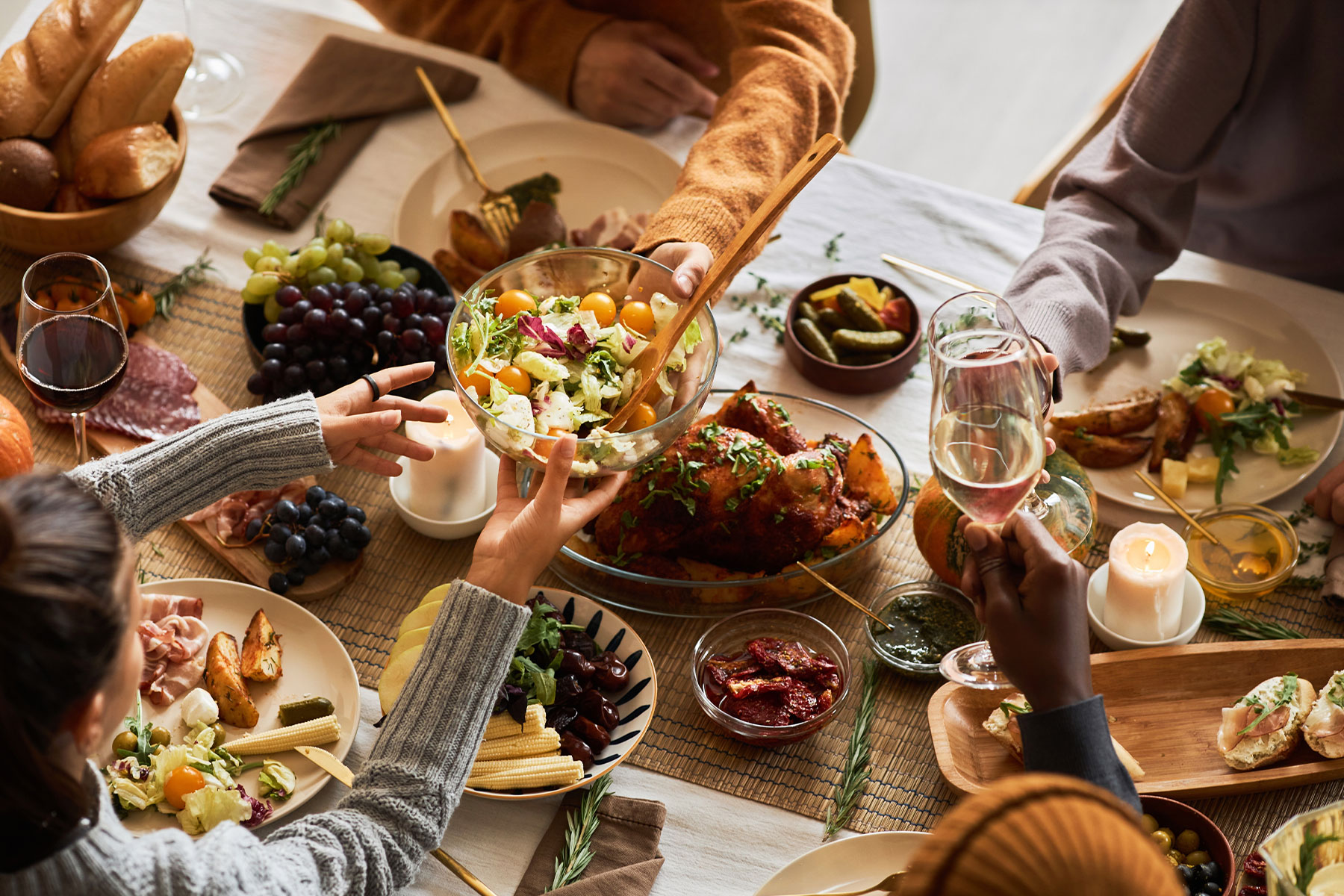 overhead view of thanksgiving table, people passing food to each other