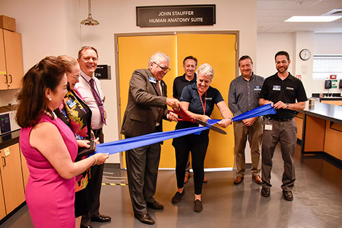 Coastline dignitaries and leadership take part in the ribbon cutting ceremony for the new lab
