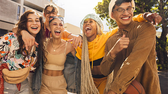 group of lively, excited, diverse gen z friends