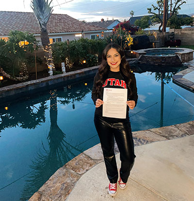 Vianca poses for a portrait with her UPAP acceptance letter 