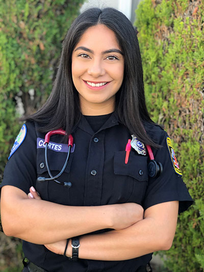 Vianca posing in her EMT uniform