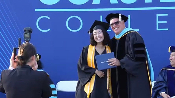 Lexi receives her diploma and poses for a photo with Coastline College President Dr. Vince Rodriguez