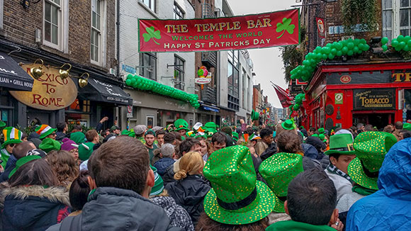 a crowd celebrates st. patricks day outside Dublin's famous Temple Bar