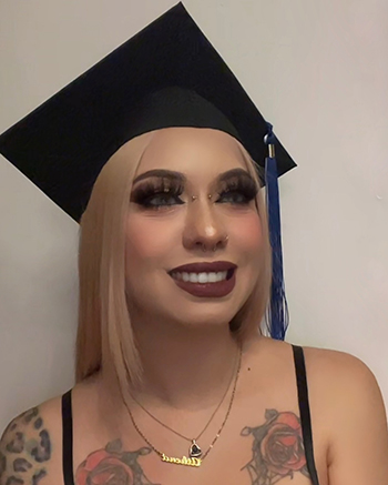 Fall 2023 Coastline Graduate Athena Nino poses for a selfie in a graduation cap