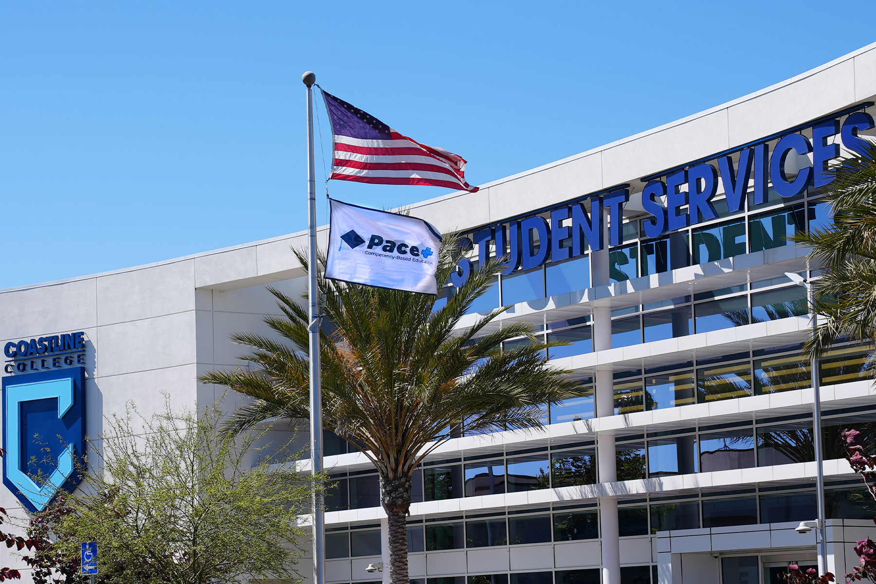 pace plus flag flying in front of student services center