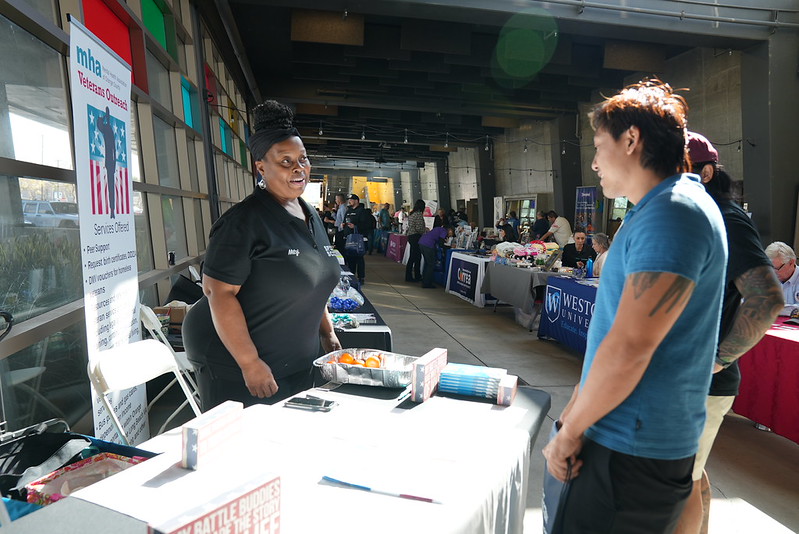 men speaking to a MHA representative