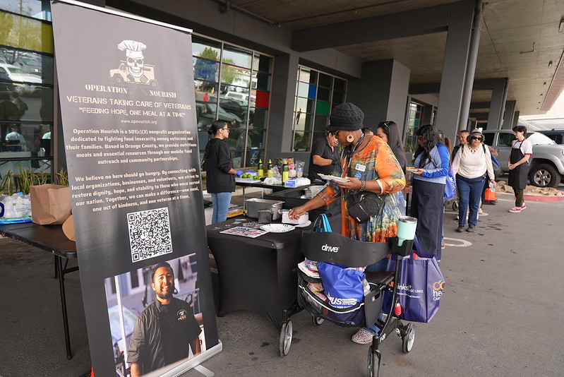 Food vendor making tacos for participants waiting in line