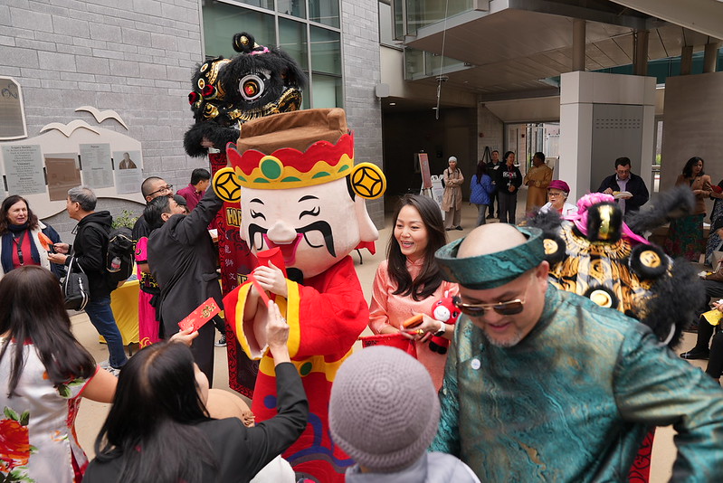 People greeting interacting with a New Year lion