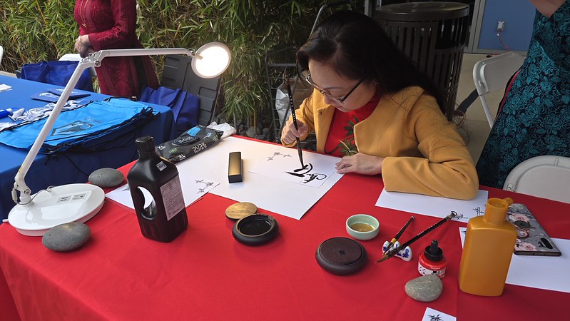 asian woman performing calligraphy