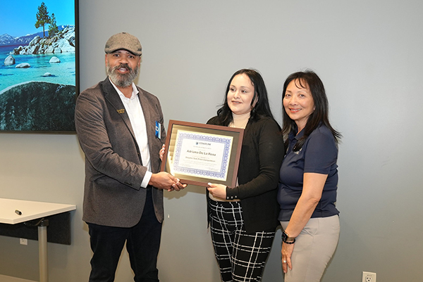 Adriana De La Rosa receiving a recognition