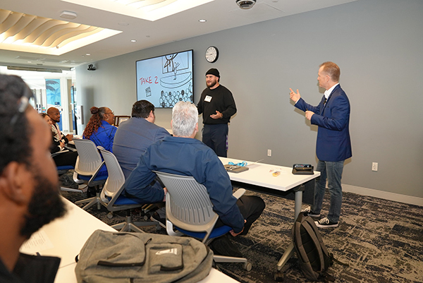 Ryan Foland giving speaking advice to a student.