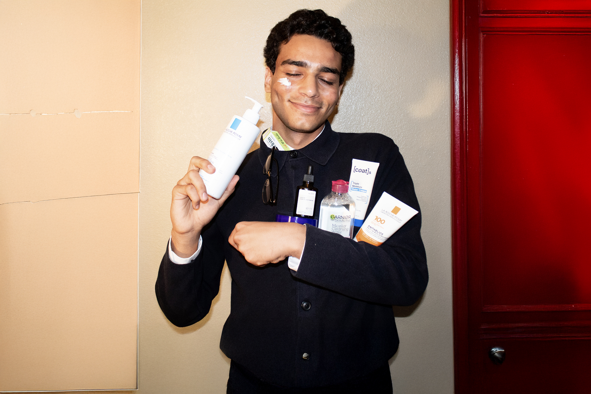 Ahmad Hamida holding skincare products