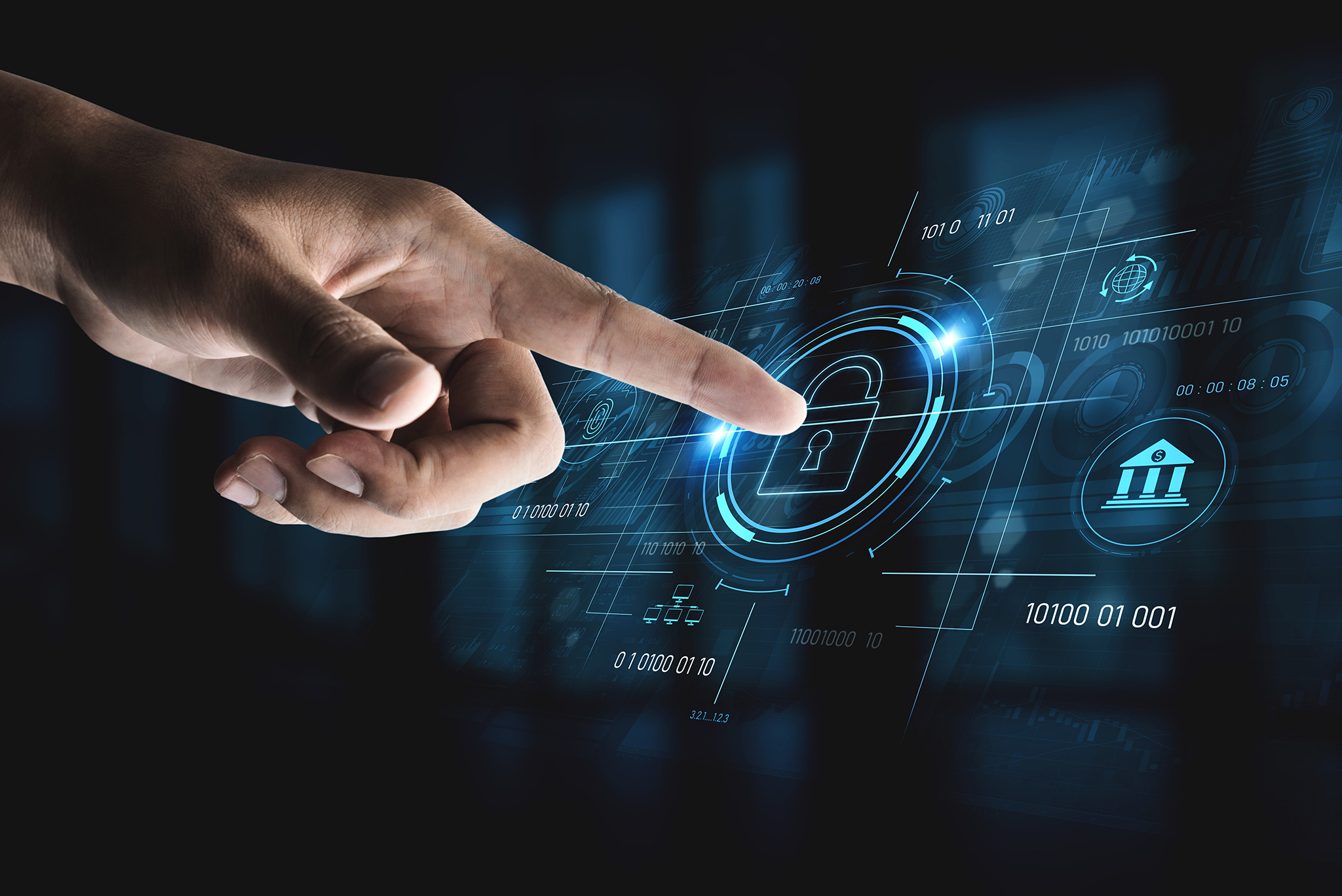 finger touching a monitor showing a cybersecurity graphic